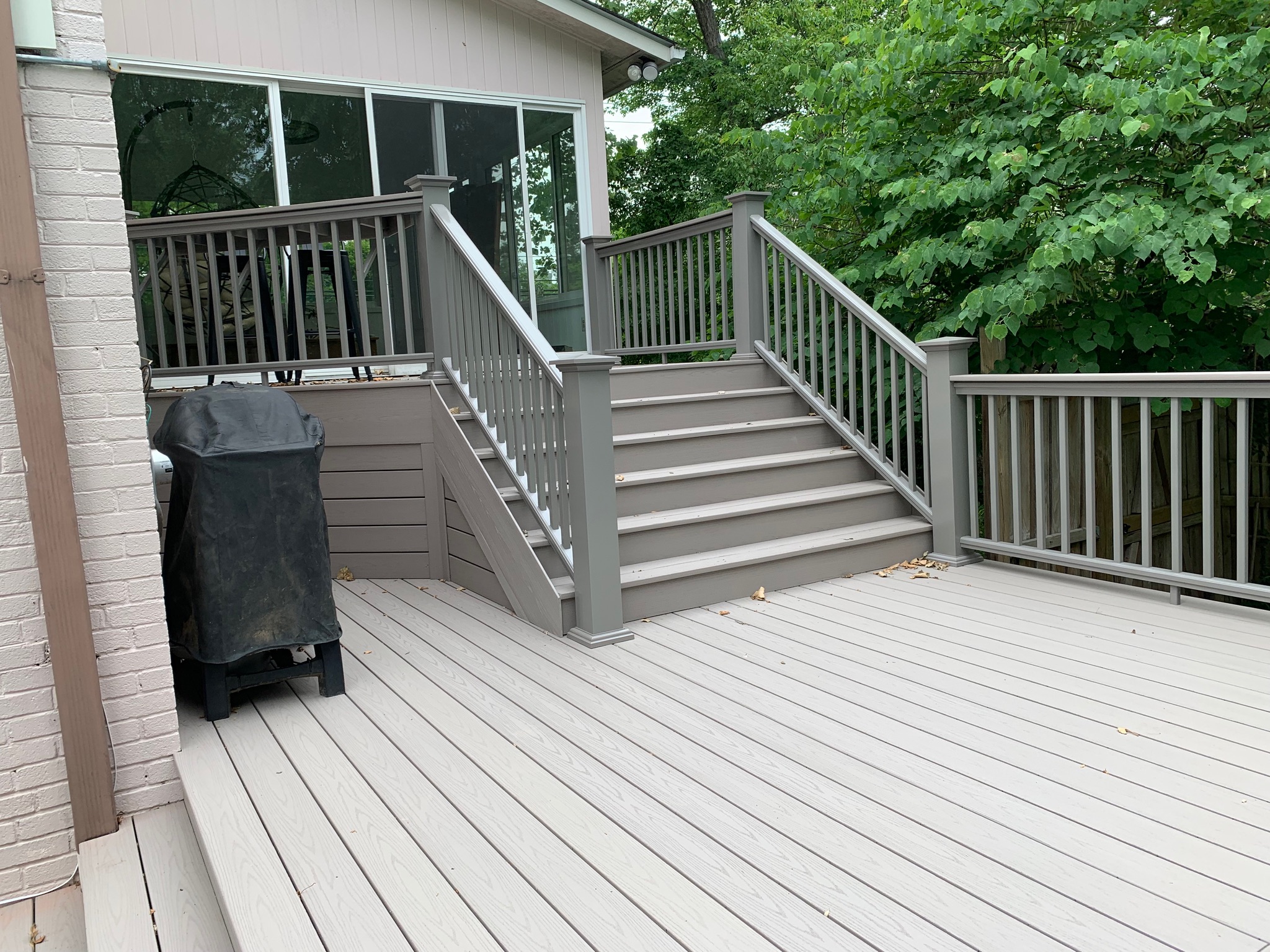 A deck with a trash can and stairs