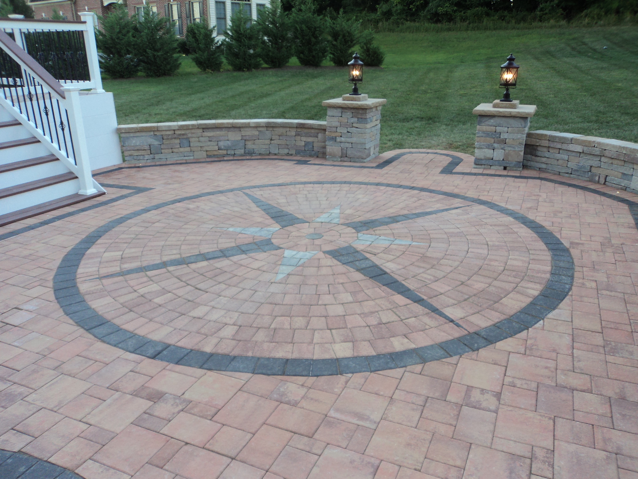 A brick patio with a circular design on it