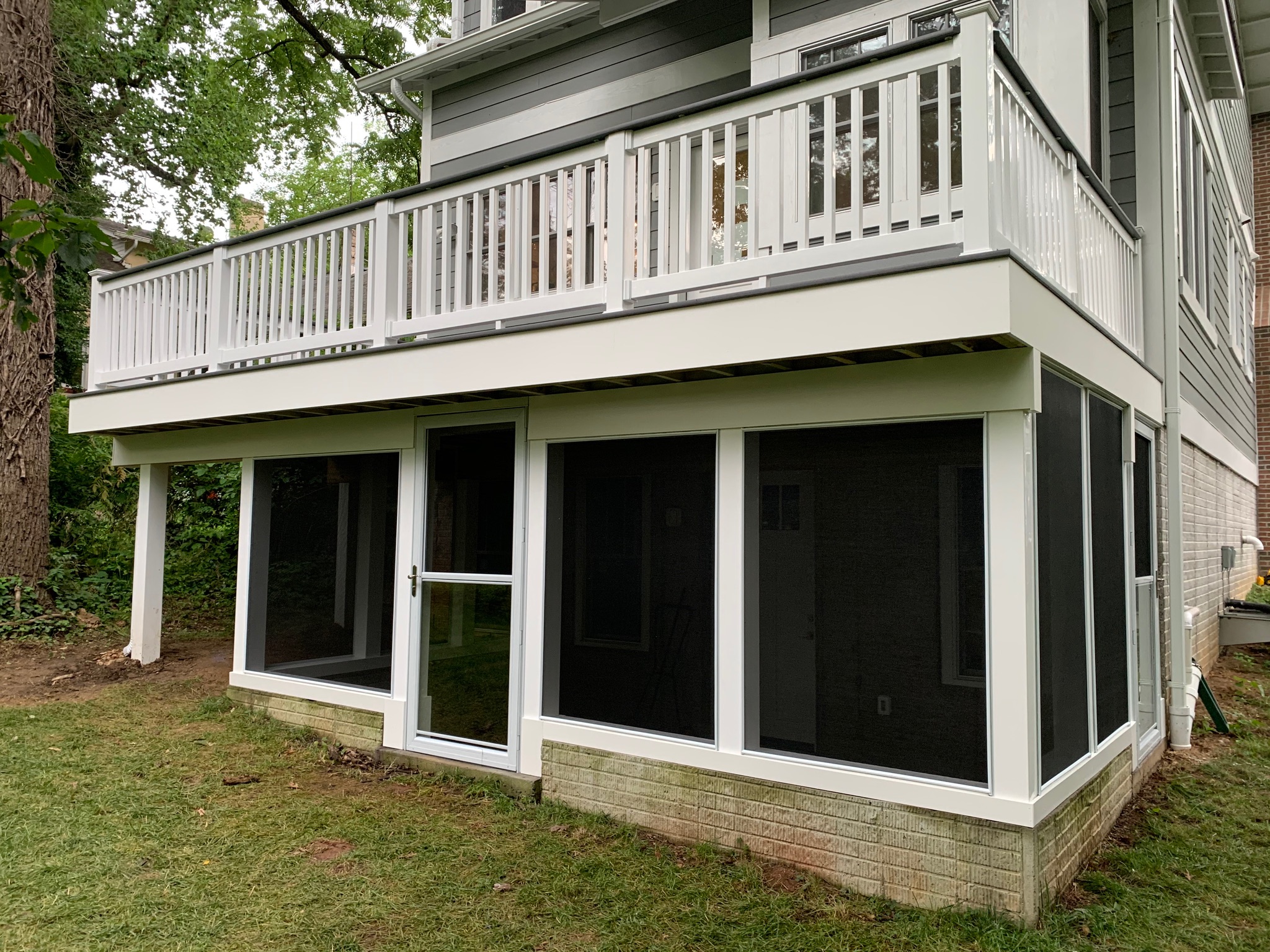 A large white house with a deck and windows