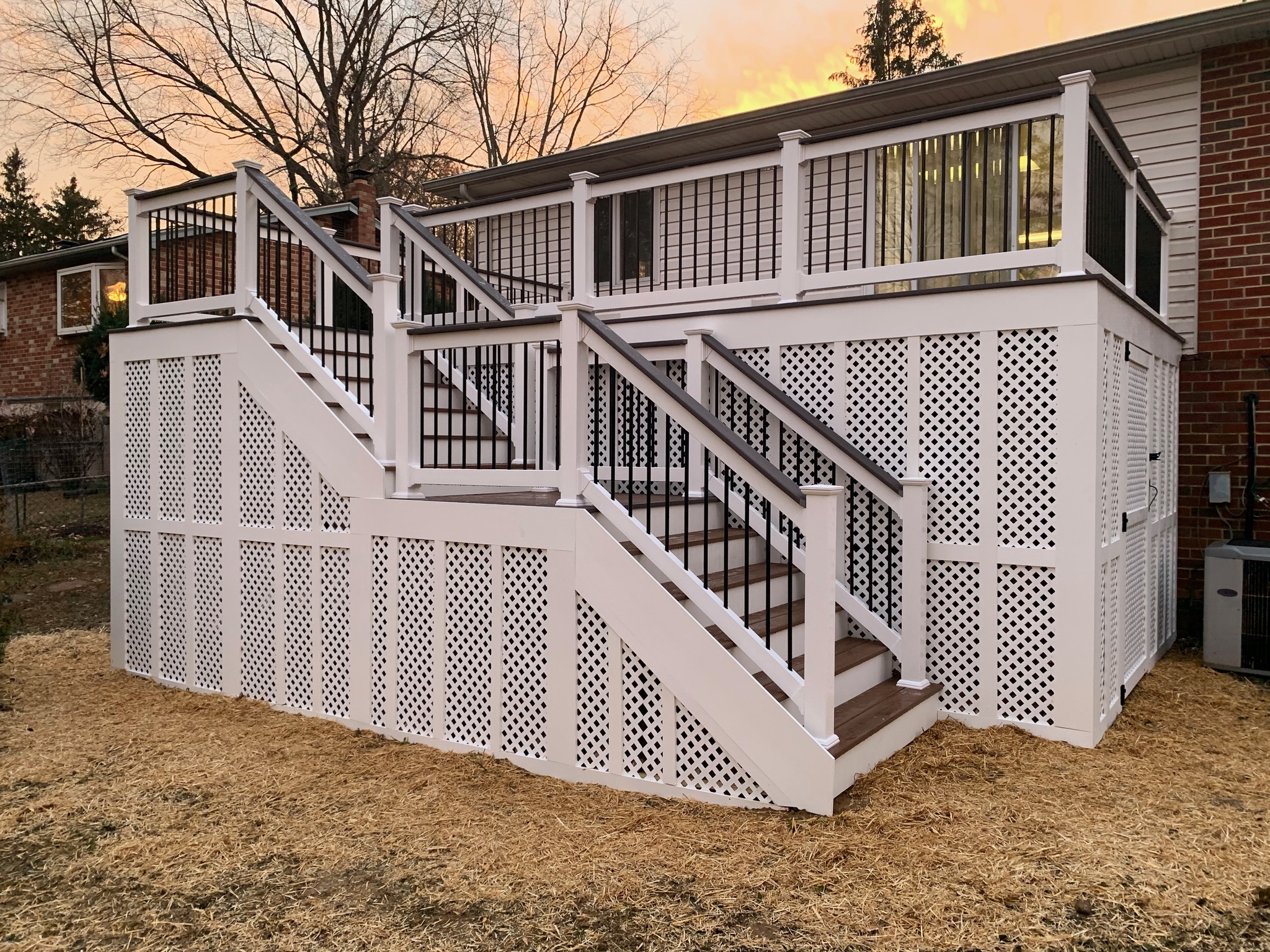 A white house with a deck and stairs