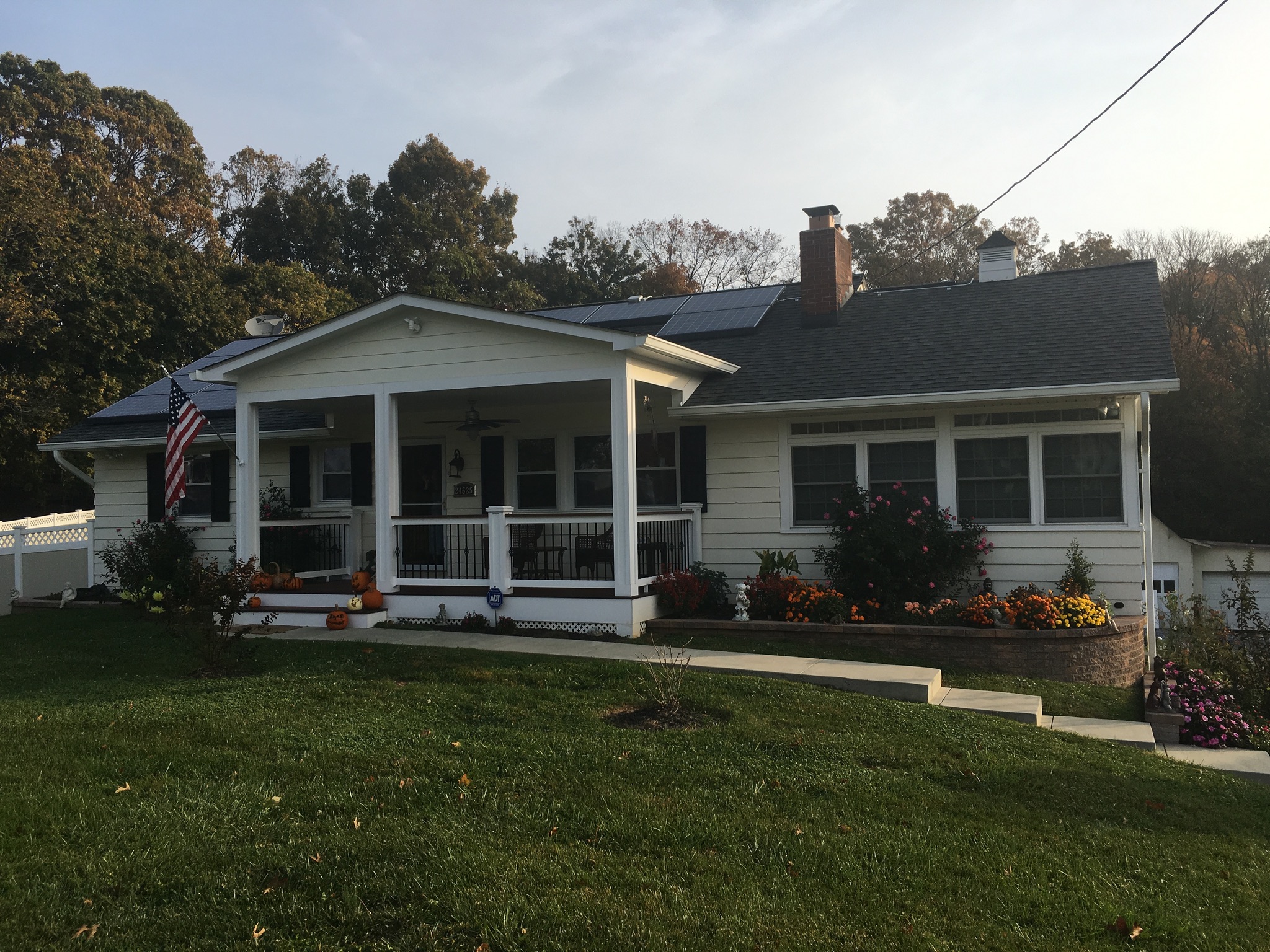 A white house with a flag on the front porch