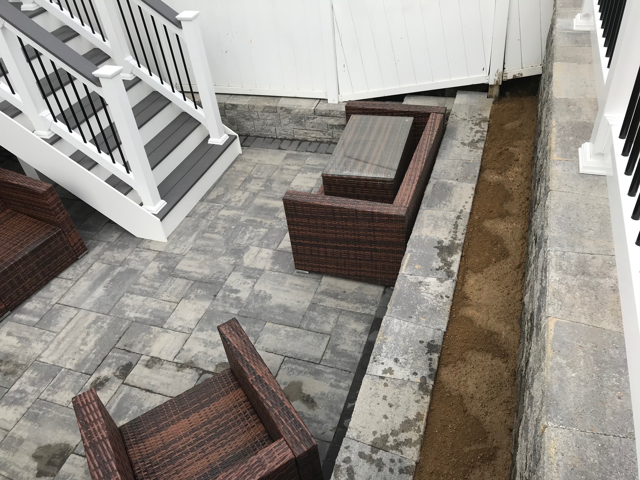 A couple of brown chairs sitting on top of a stone floor