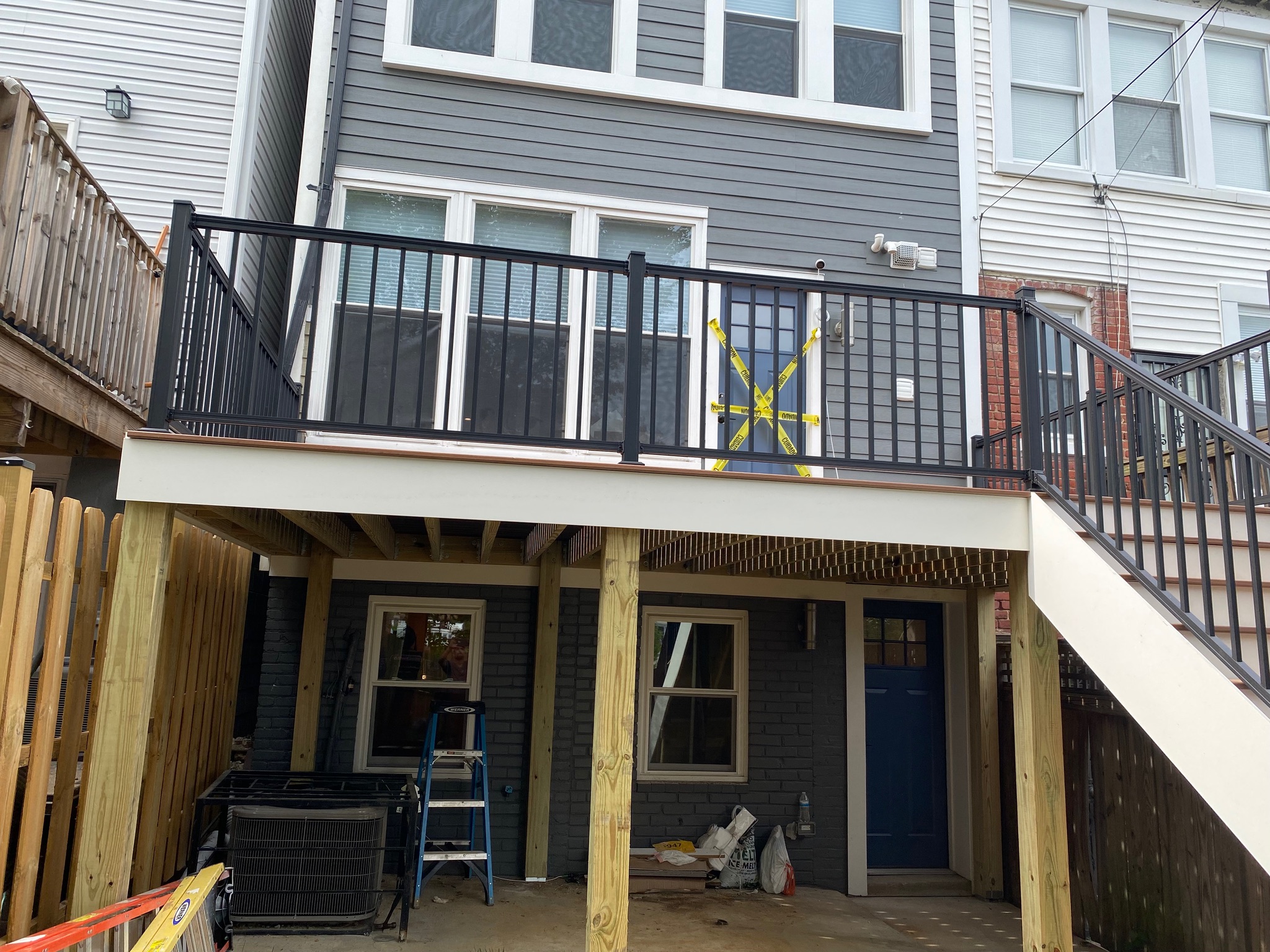 A house with a deck and a stair case