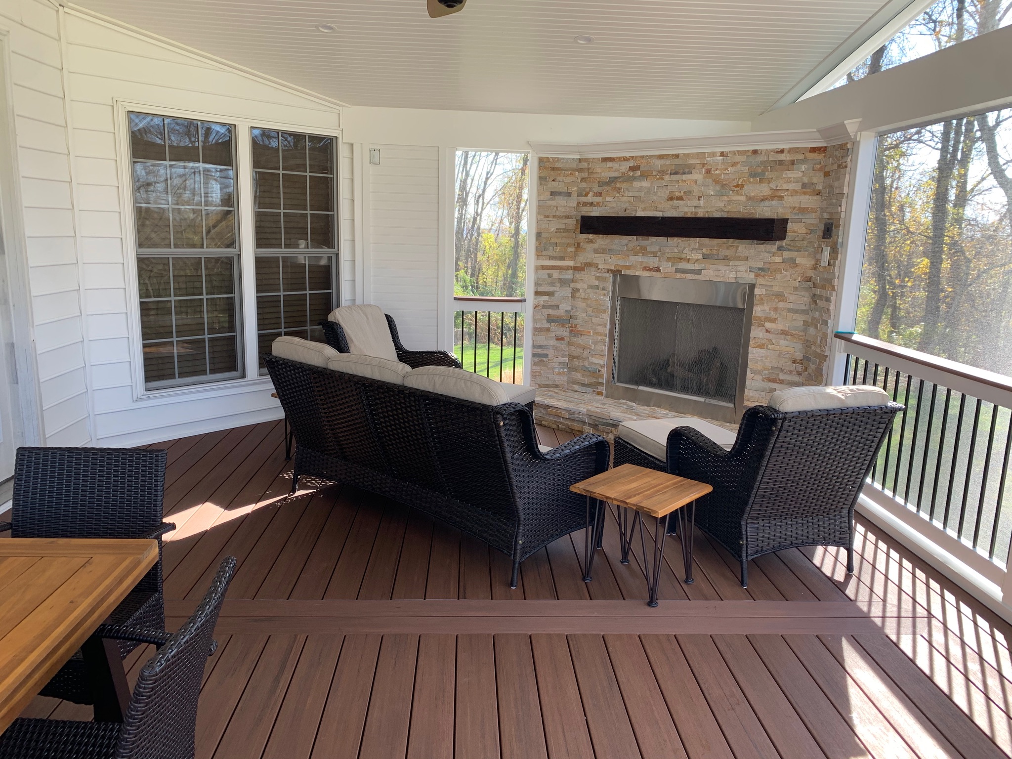 A patio with a fireplace and chairs on it