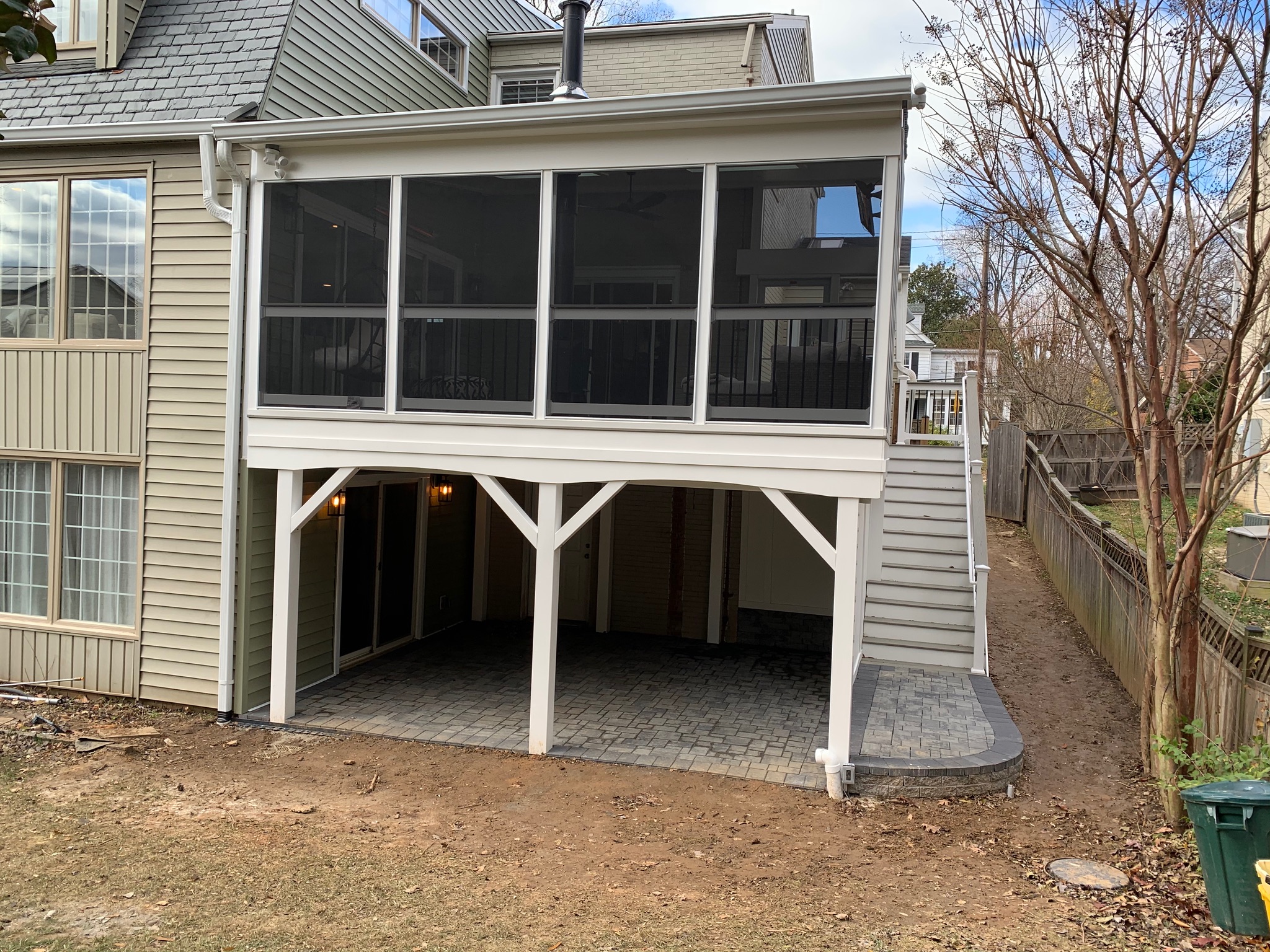 A two story house with a screened porch