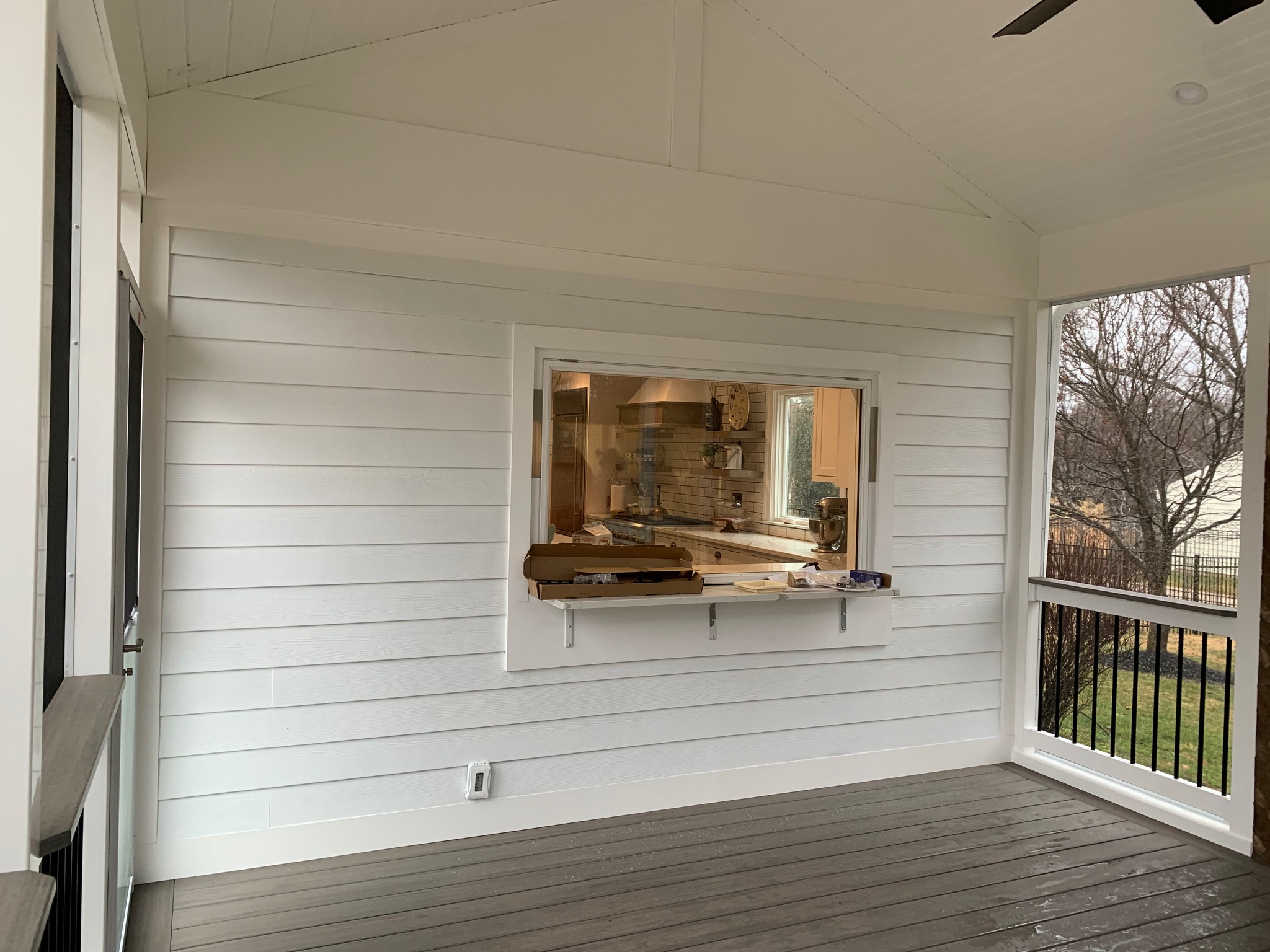 A room with a ceiling fan and a window