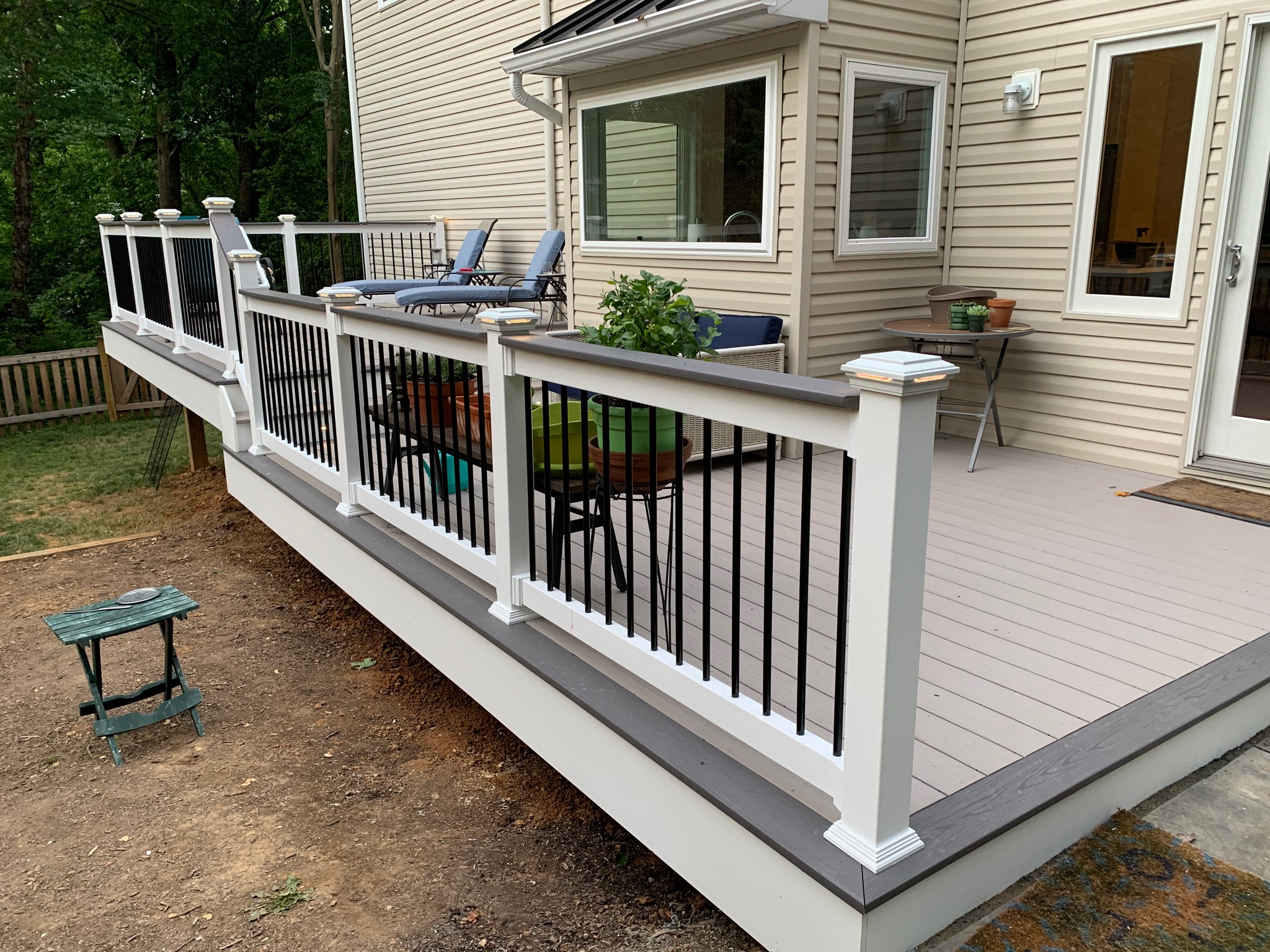 A deck with a table and chairs on it