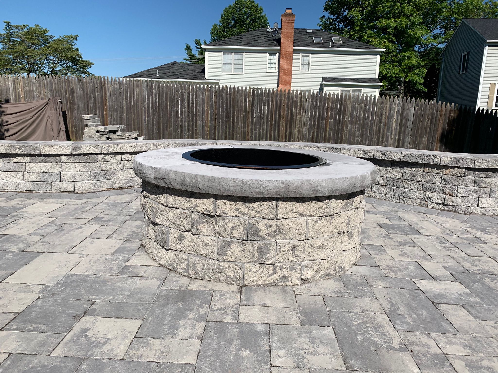 A fire pit sitting on top of a brick patio