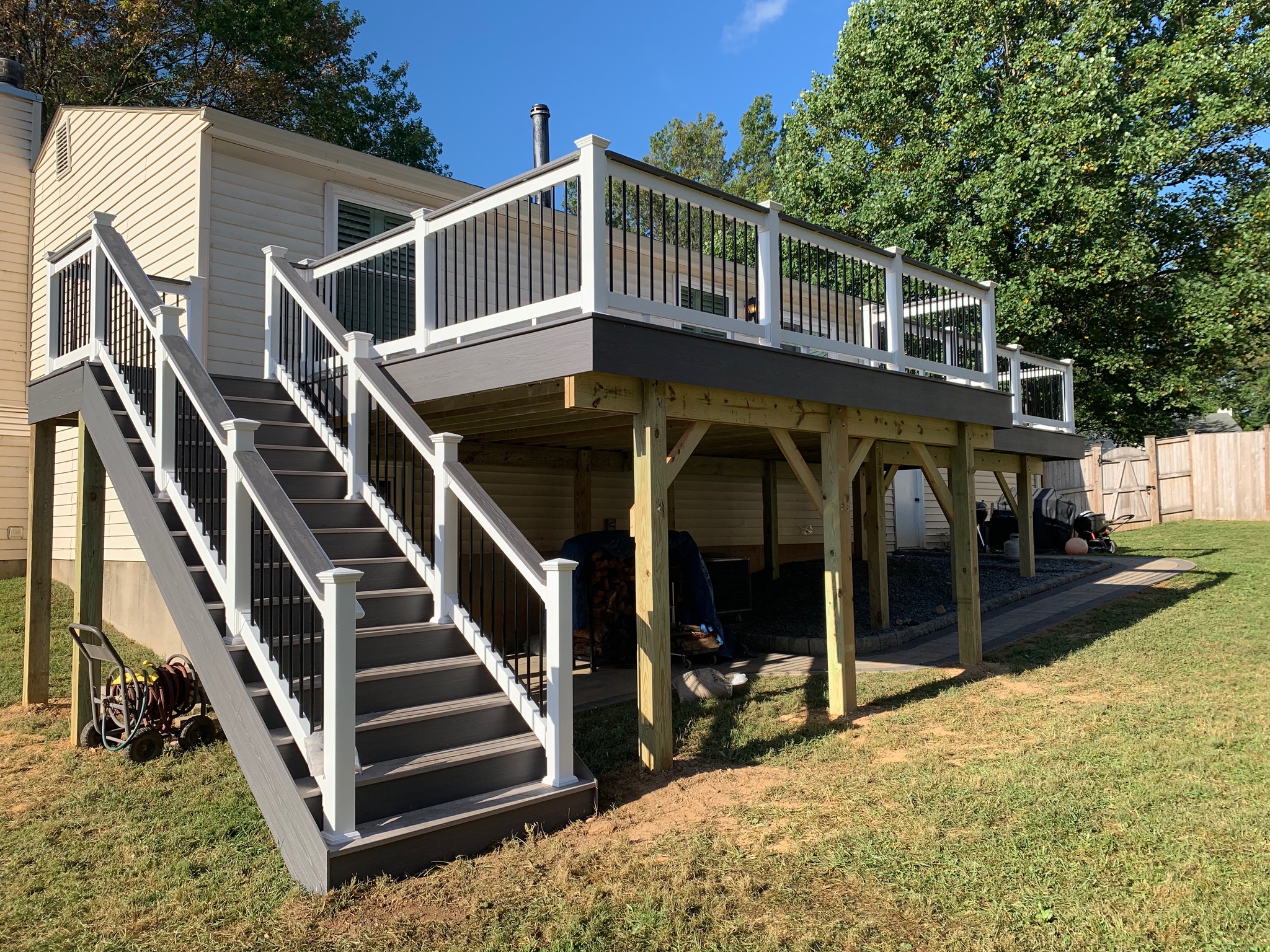 A house with a deck and stairs in the yard