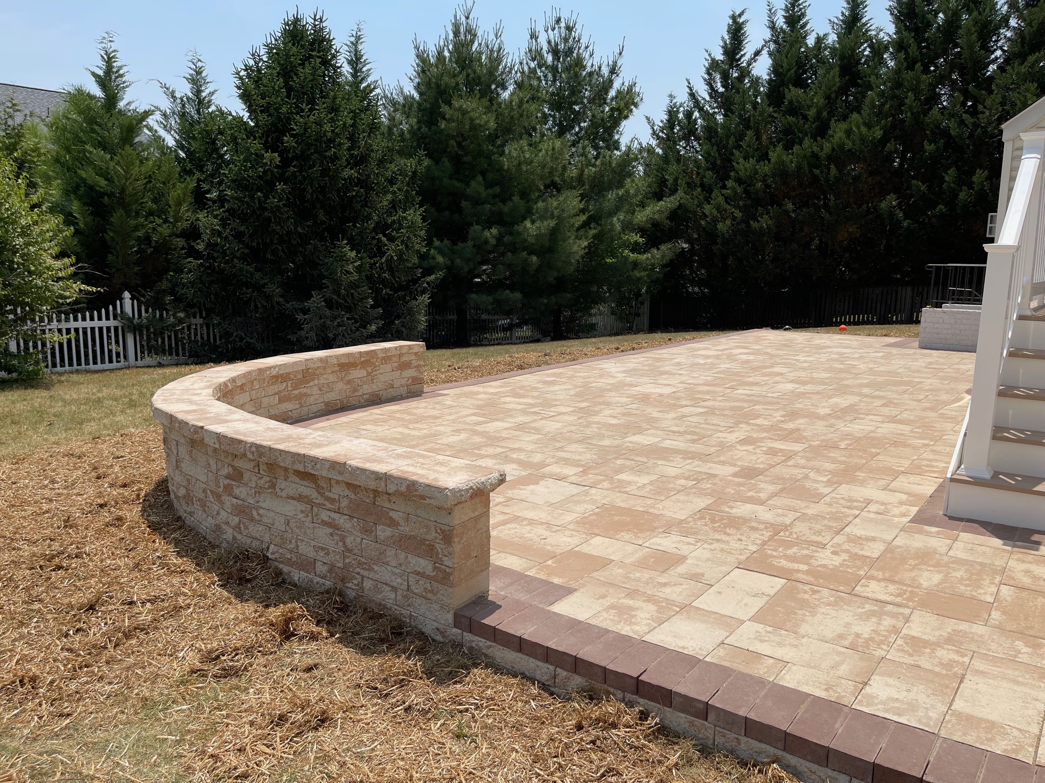 A brick patio with steps leading up to it