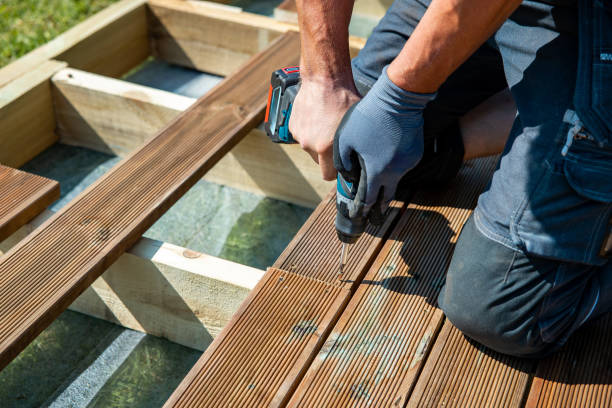Crew building custom backyard deck beside Rockville home with steps and railing
