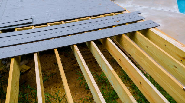 Deck framing inspection showing careful alignment, secure connections, and professional outdoor construction methods