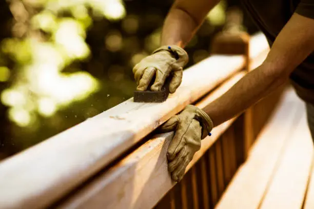 Backyard deck installation underway beside suburban Howard County home with new stairs